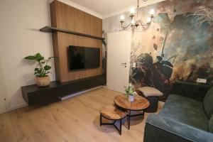 a living room with a couch and a table at Appartement Promenadenhirsch in Bad Gastein