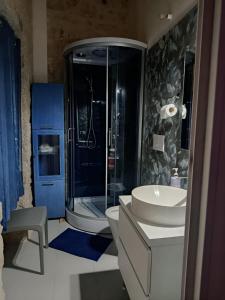 a bathroom with a toilet and a sink and a shower at La casa di Jacopo in Modica +11 photos