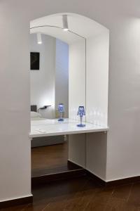 a white room with two blue lamps on a table at Tiare' in Trani +56 photos