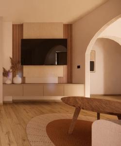a living room with a tv and a table at Theo's Garden Villa in Kefalos