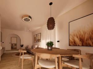a living room with a wooden table and chairs at Theo's Garden Villa in Kefalos