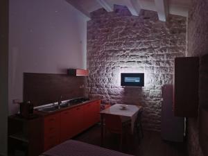 a kitchen with a sink and a brick wall at La casa di Jacopo in Modica