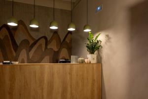 a lobby with a counter with potted plants and lights at Hotel Villa de Alquézar in Alquézar +95 photos