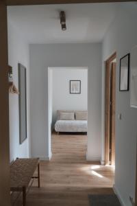 a hallway with a bed in a white room at "LOKAL" Apartment 1 in Bad Muskau