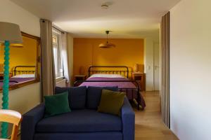 a living room with a couch and a bed at Droom op de Vijlenberg in Vijlen