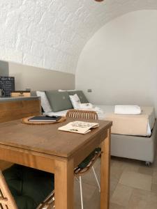 a room with a table with a bed in the background at Wonderhouse in Polignano a Mare