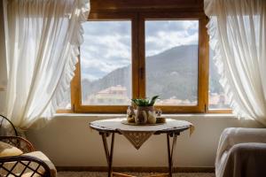 a table in front of a window with a view at Soffitta House Sofi! in Florina