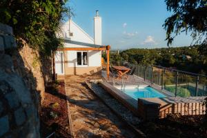 a house with a swimming pool and a church at Napajedla in Znojmo