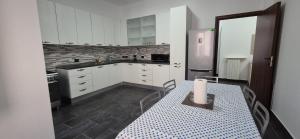 a kitchen with white cabinets and a table with a candle on it at Arenzano rooms in Arenzano