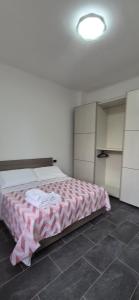 a bedroom with a large bed with a pink blanket at Arenzano rooms in Arenzano
