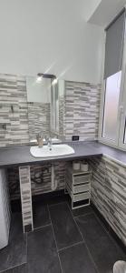 a bathroom with a sink and a mirror at Arenzano rooms in Arenzano