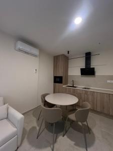 a living room with a table and chairs and a couch at Casa Centro in Hervás