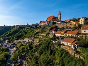 a village on a hill with a church at Napajedla in Znojmo