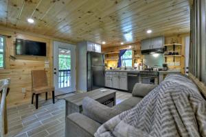 a living room with a couch and a kitchen at Ocoee Cottage Water Front in Copperhill