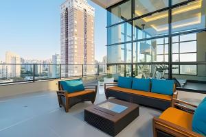 a living room with a view of a city at Exclusivo, Moderno e Completo in Campinas