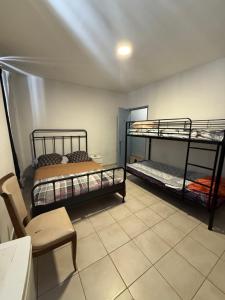 a room with two bunk beds and a table and a chair at Hotel baille castellane in Marseille