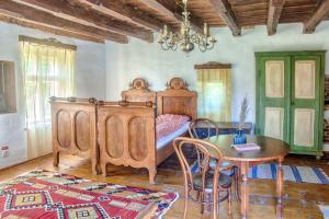 a bedroom with a wooden bed and a table and a tableablish at Dominic Boutique - Casa Mare in Cloaşterf +35 photos