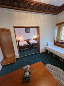a hotel room with two beds and a mirror at Комплекс ,,Трявна" in Tryavna +32 photos