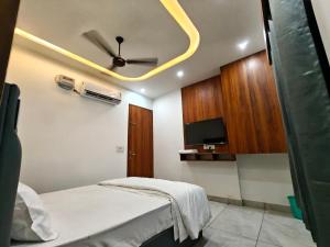 a room with a bed and a ceiling fan at Ora Stay in Pānīpat
