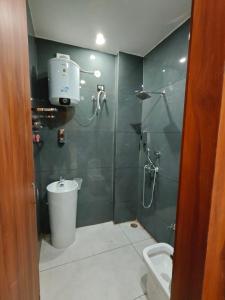 a bathroom with a shower with a toilet and a sink at Ora Stay in Pānīpat