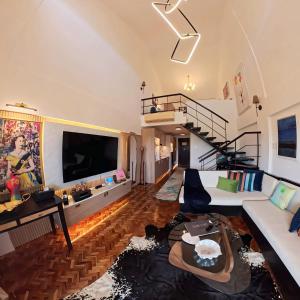 a living room with a couch and a tv at Raffy White Boracay in Boracay