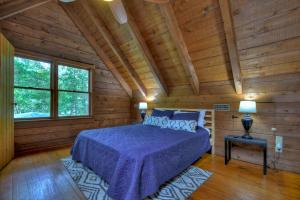 a bedroom with a bed and a wooden ceiling at Oscars Outpost Fire Pit Pet Friendly in Mineral Bluff