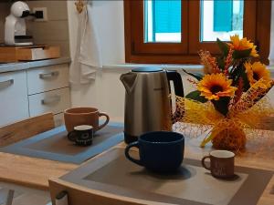 a kitchen counter with two cups and a coffee maker at Marruvium 1937's in Avezzano