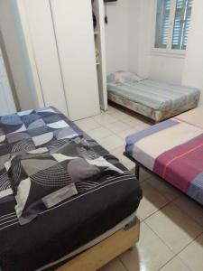 a room with two beds in a room at Hotel baille castellane in Marseille