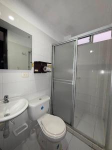 a bathroom with a shower and a toilet and a sink at Villalba Boutique Hotel in Valledupar