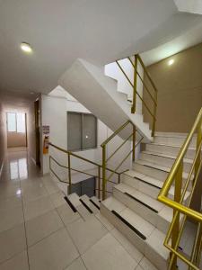 a staircase in a building with a yellow railing at Villalba Boutique Hotel in Valledupar