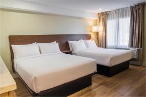 a hotel room with two beds and a window at Skye Hotel Ridgetown in Ridgetown
