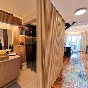 a kitchen and living room with a wooden wall at Raffy White Boracay in Boracay +23 photos