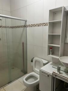 a bathroom with a shower and a toilet and a sink at Chácara HZ in Sao Jose do Rio Preto +19 photos