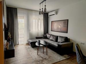 a living room with a couch and a table at KM Lux & SPA in Veliko Gradište
