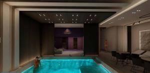 a swimming pool in a room with a table and chairs at KM Lux & SPA in Veliko Gradište
