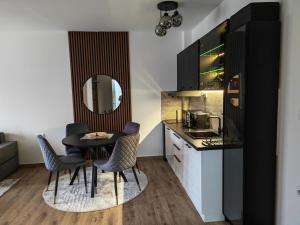 a small kitchen with a table and chairs in a room at KM Lux & SPA in Veliko Gradište