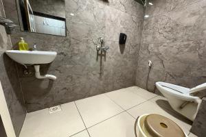 a bathroom with a sink and a toilet at Hotel Anantshree Inn Shree Mahakaleshwar Temple Ujjain in Ujjain