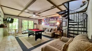 a living room with a ping pong table in it at Pine Bluff on the Lake in Golden