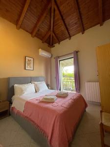 a bedroom with a large bed with a window at Olive & Sea Villa Koroni in Koroni