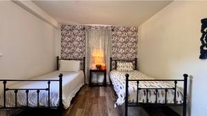 a bedroom with two beds and a window at Pine Bluff on the Lake in Golden