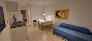 a living room with a blue couch and a table at Alquiler cintia in Gualeguaychú