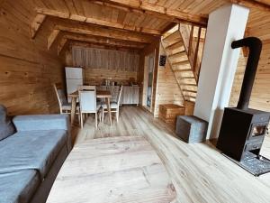 a living room with a couch and a wood stove at Bujtina n'kullë in Boge