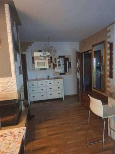 a kitchen with a white dresser and a counter at Apartament dwupoziomowy z 2 sypialniami in Ujazdowo +8 photos