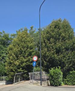 a street light with a sign on a pole at Green House Residence in Pinerolo