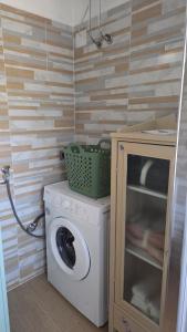 a washer and dryer in a small bathroom at Green House Residence in Pinerolo