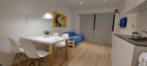 a small room with a table and a blue couch at Alquiler cintia in Gualeguaychú