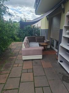a couch sitting on the patio of a house at Apartament dwupoziomowy z 2 sypialniami in Ujazdowo