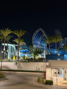 a water park at night with a roller coaster at Marassi- Faya Residence in El Alamein