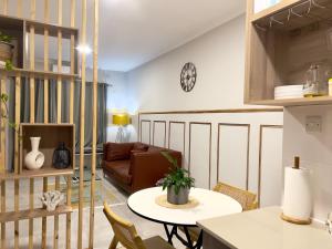 a living room with a table and a couch at Sarona LoLa E206 in Gaborone
