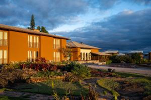 an orange building with a garden in front of it at Casarão Alpina in Mucugê